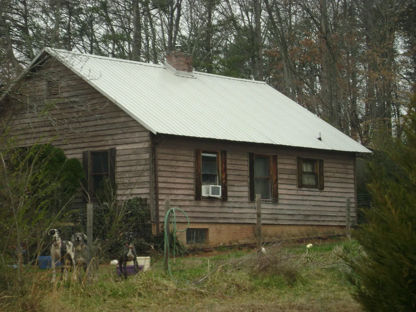 White metal roof on an old wood sided farmhouse, from a Metal Roof Installation job in Westbrook